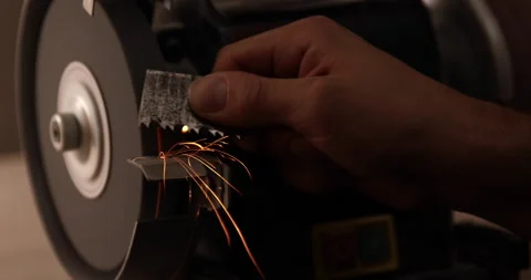 Closeup of abrasive disc on bench grinder machine Video stock 233598547