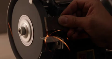 Closeup of abrasive disc on bench grinder machine Video stock 233599468