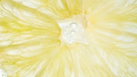 Closeup abstract image of pulp and juice of ripe lime on white backgorund Foto stock