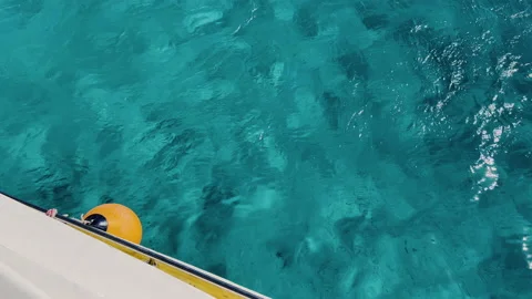 Closeup abstract of surface blue water with a yacht for background. Reflection Stock Footage 199233821