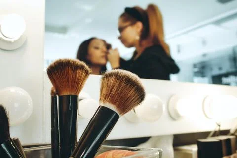 Closeup of accessory brushes with a professional make-up artist in a studio Stock Photos