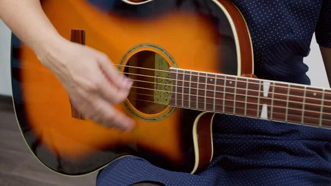 Closeup of acoustic guitar strings being played Stock Footage 317359485
