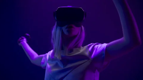 Closeup active gamer testing VR technology. Futuristic goggles youngster playing Stock Footage 205519203