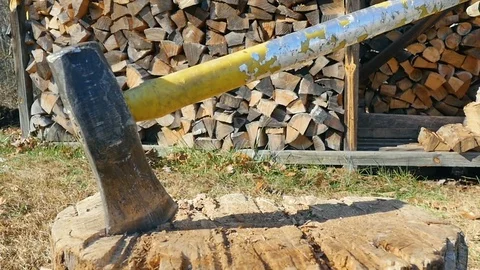 Closeup of an Active Senior Man Swinging an Axe into a Tree Stump in Slow Motion Stock Footage 84291033
