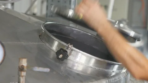 Closeup of adding hops in the brewing unit on a beer production Stock Footage 91688012