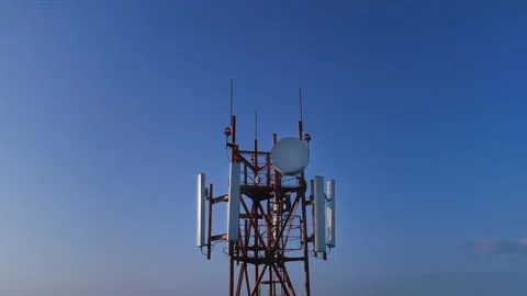 Closeup aerial view on the telecommunication tower with 5g 4g cellular dishes Stock Footage 137761188