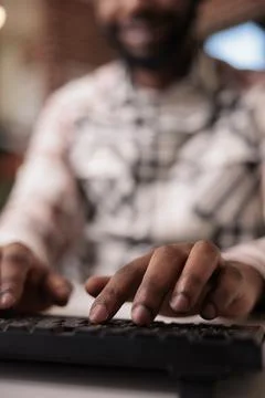 Closeup of african american coder writing software using computer keyboard while 库存照片
