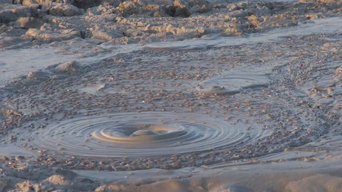 Closeup amazing mud volcano eruption by day Stock Footage 129998948