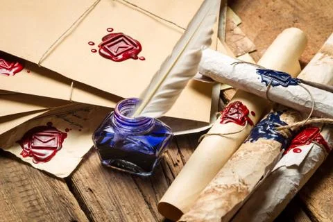 Closeup of ancient scrolls and old envelope with blue inkwell 스톡 사진
