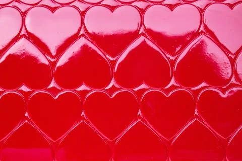 A closeup and macro view of a red heart textured background pattern, repeatin 스톡 사진