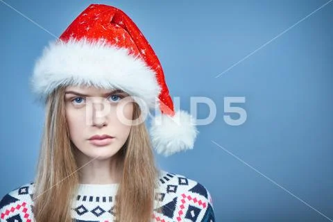 Closeup of Angry frowning woman wearing Santa hat Stock Photos