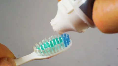 Closeup: applying toothpaste on a toothbrush. Stock Footage 104090497