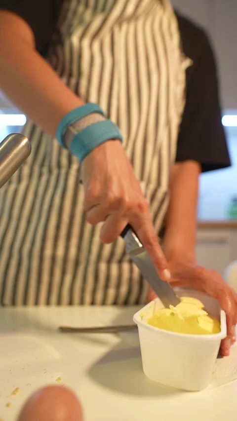 Closeup of apprentice chopping firm cold butter with precision Stock Footage 346483249