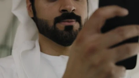 Closeup of an arab man texting on his mobile. Stock Footage 126310645