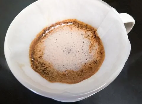The closeup of the arabica ground coffee in the process of brewing from pouri Stock Photos