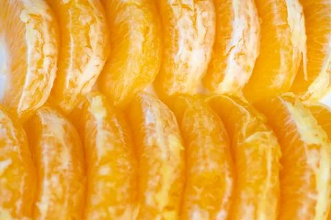 Closeup arranged orange segments creating symmetrical pattern, soft shadow an 写真素材