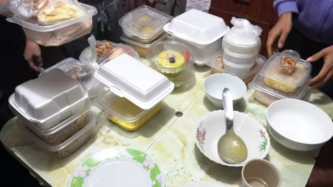 Closeup arranging several white containers of seafood for delivery at a family Stock Footage 156443012