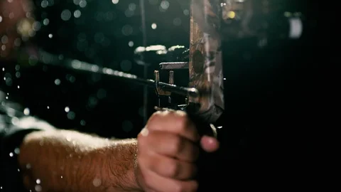 Closeup of arrow being shot from bow, water drizzling Stock Footage 99125758