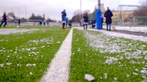 Closeup of artificial turf with a white line, fresh snow covering the ground, cr Stock-Footage 295931595