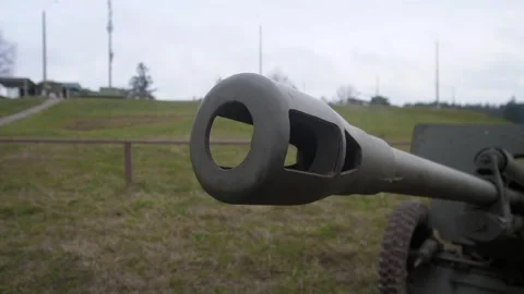 Closeup artillery barrel muzzle view on grassy field, weathered steel and patina Stock Footage 321264756