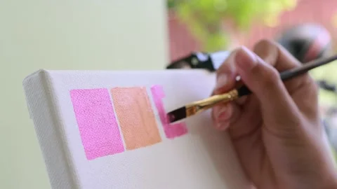 Closeup artist hand using brush acrylic painting on canvas frame Stock Footage 196561553