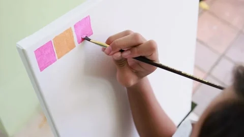 Closeup artist hand using brush acrylic painting on canvas frame Stock Footage 196561686