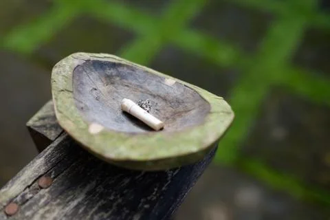 Closeup ashtray with one cigarette Stock Photos