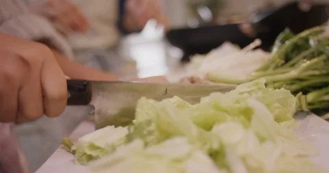 Closeup of Asian cabbage being sliced in kitchen Stock Footage 123788294
