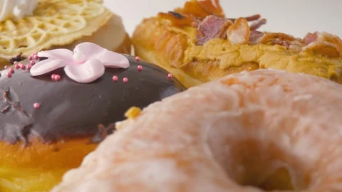 Closeup on an Assortment of Gourmet Donuts Stock Footage 106048309