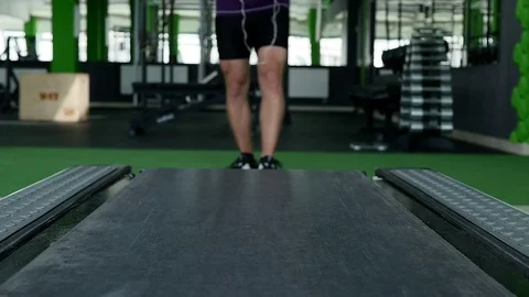 Closeup of athlete's feet running on treadmill Stock Footage