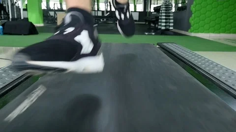 Closeup of athlete's feet running on treadmill Stock Footage