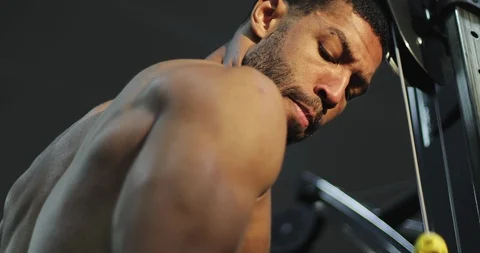 Closeup athletic black male training with cable sport simulator in gym workout. Stock Footage 101343645