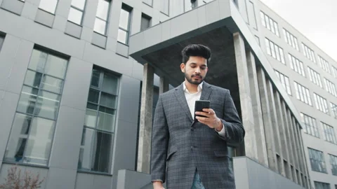 CloseUp of Attractive Young Businessman using Smartphone and Smiles. Texting Stock Footage 156546301