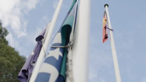 Closeup of Australian, Aboriginal and Torres Strait Island flags on a flagpole Stock Footage 116694903