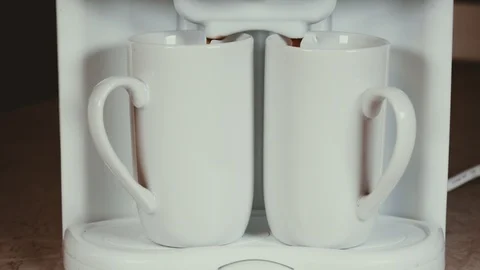 Closeup of automatic coffee machine or coffeemaker pouring espresso coffee in Stock Footage 101646397