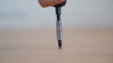 Closeup automatic screw driver untighten screw from wood Stock Footage 129549157