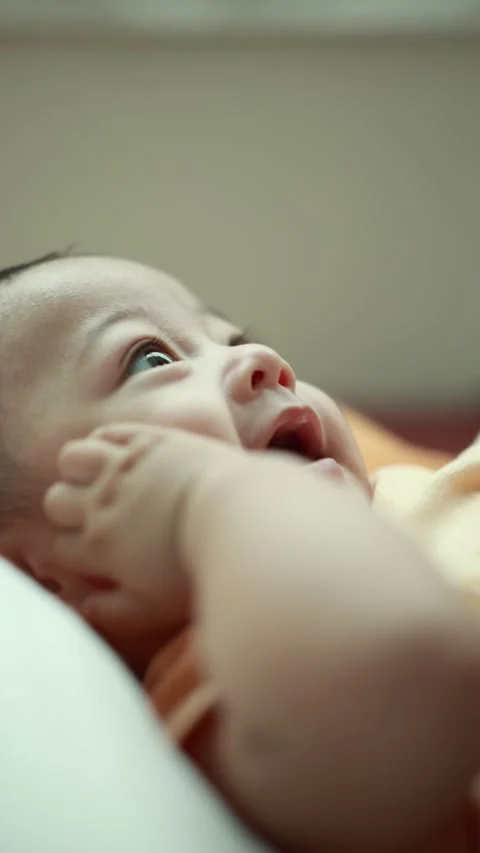Closeup of a baby boy on the bed Stock Footage 333889394