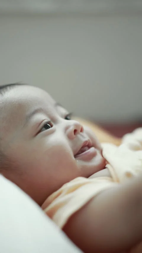 Closeup of a baby boy on the bed Stock Footage 333889427