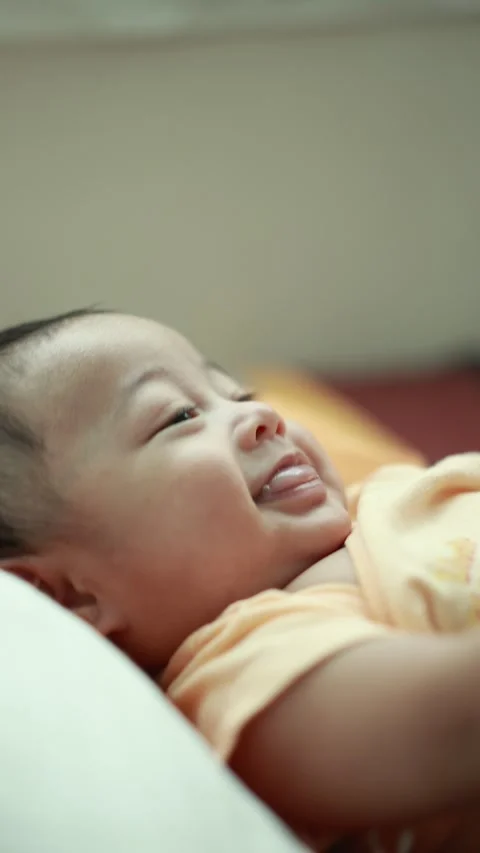 Closeup of a baby boy on the bed Stock Footage 333889460