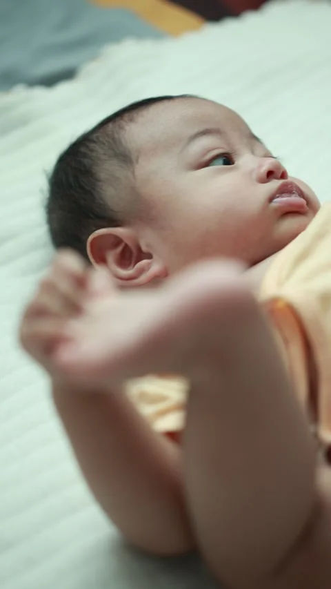 Closeup of a baby boy on the bed Stock Footage 333889485