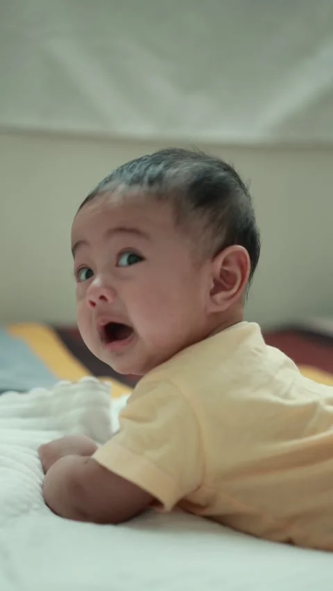 Closeup of a baby boy on the bed Stock Footage 333889493
