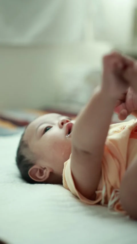 Closeup of a baby boy on the bed Stock Footage 333889502