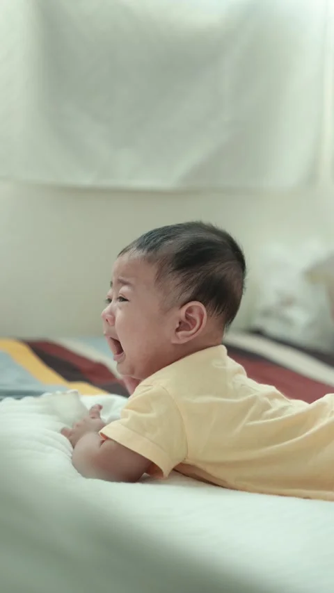 Closeup of a baby boy on the bed Stock Footage 333889523