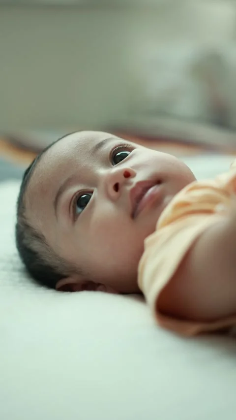 Closeup of a baby boy on the bed Stock Footage 333889532