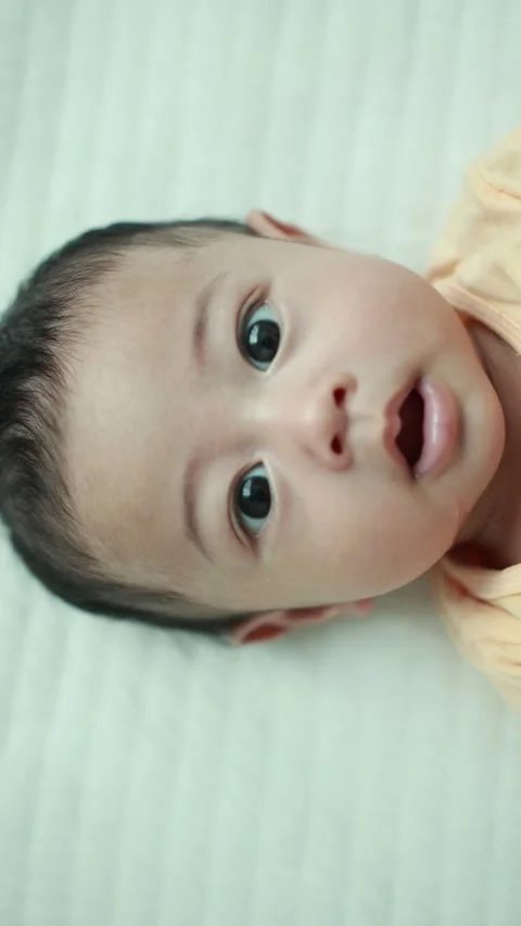 Closeup of a baby boy on the bed Stock Footage 333889537