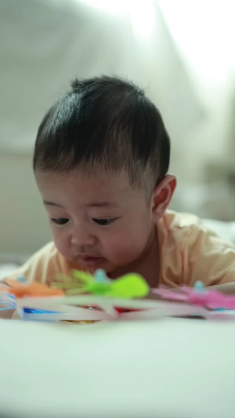 Closeup of a baby boy on the bed Stock Footage 333889543