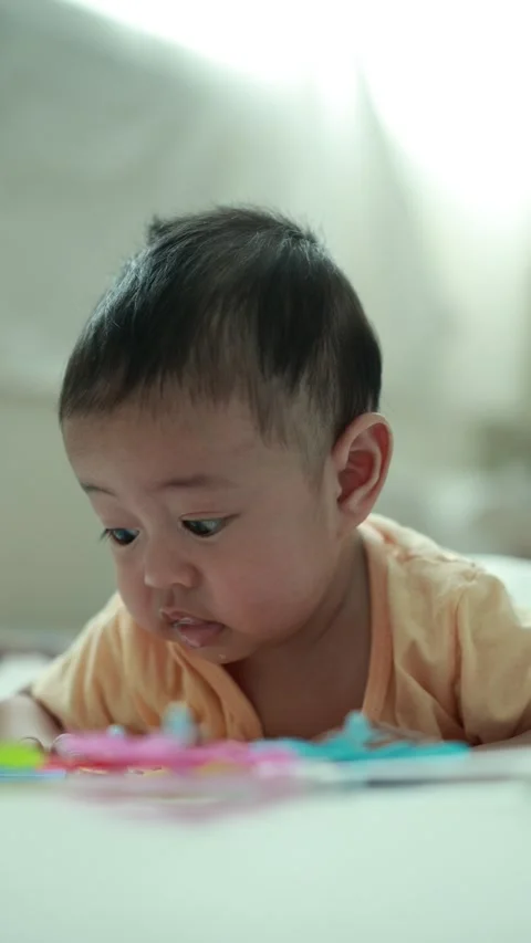 Closeup of a baby boy on the bed Stock Footage 333889552