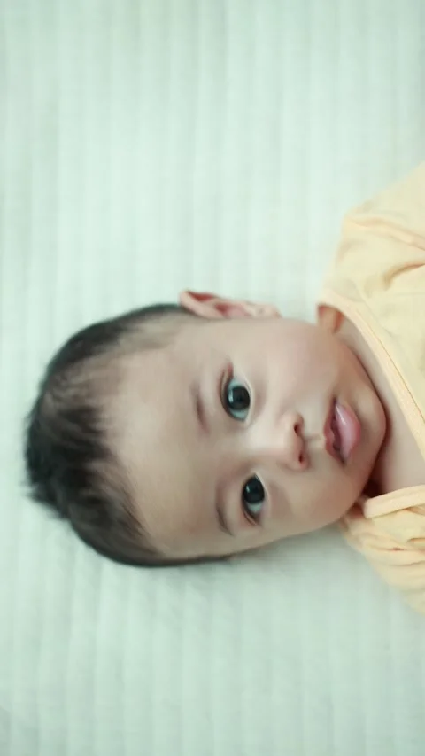 Closeup of a baby boy on the bed Stock Footage 333889560