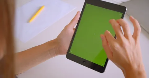 Closeup back portrait of young attractive caucasian woman using tablet with Stock Footage 114185371