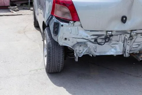 Closeup back of silver car get damaged by accident on the road. Stock Photos